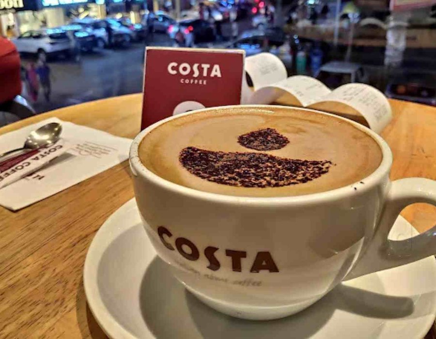 Costa Coffee branded cup and cafe interior detail